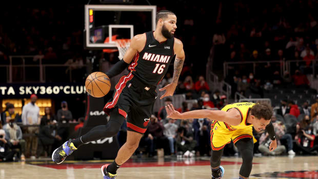 an 12, 2022; Atlanta, Georgia, USA; Miami Heat forward Caleb Martin (16) dribbles the ball against Atlanta Hawks guard Trae Young (11) during the first quarter at State Farm Arena.